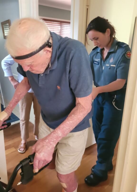 Falls physio assesses elderly patient using walking frame