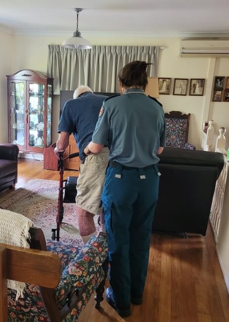 Falls physio assesses elderly patient using walking frame