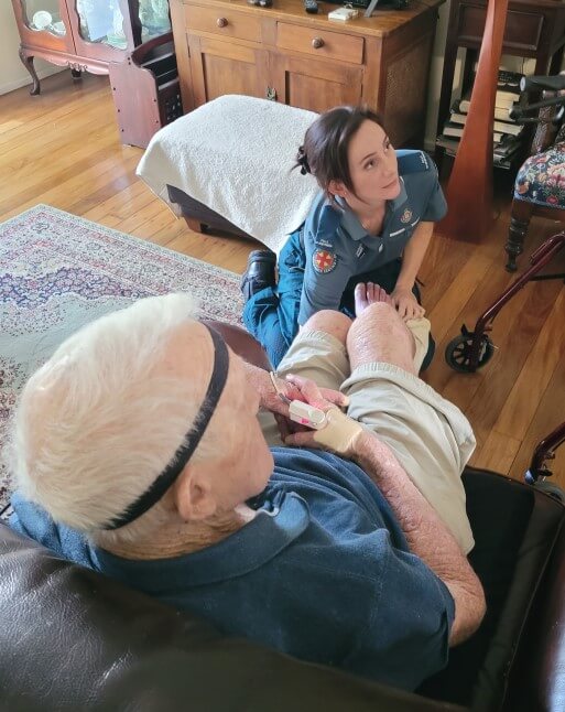 Falls physio checks patient's feet