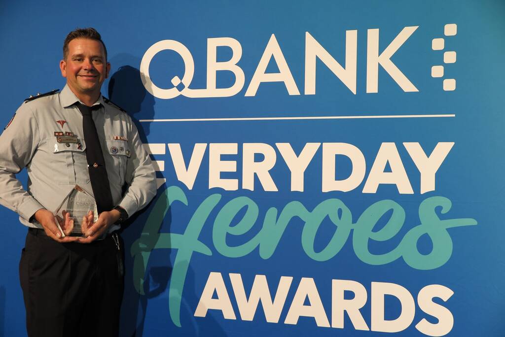 Photo of Vaughan Mason with his QBank Everyday Heroes Awards