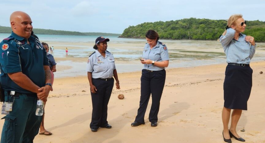 QAS staff and rangers talking on beach