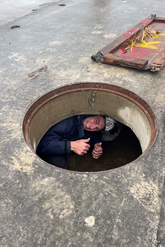 Paramedic climbing out of a tunnel