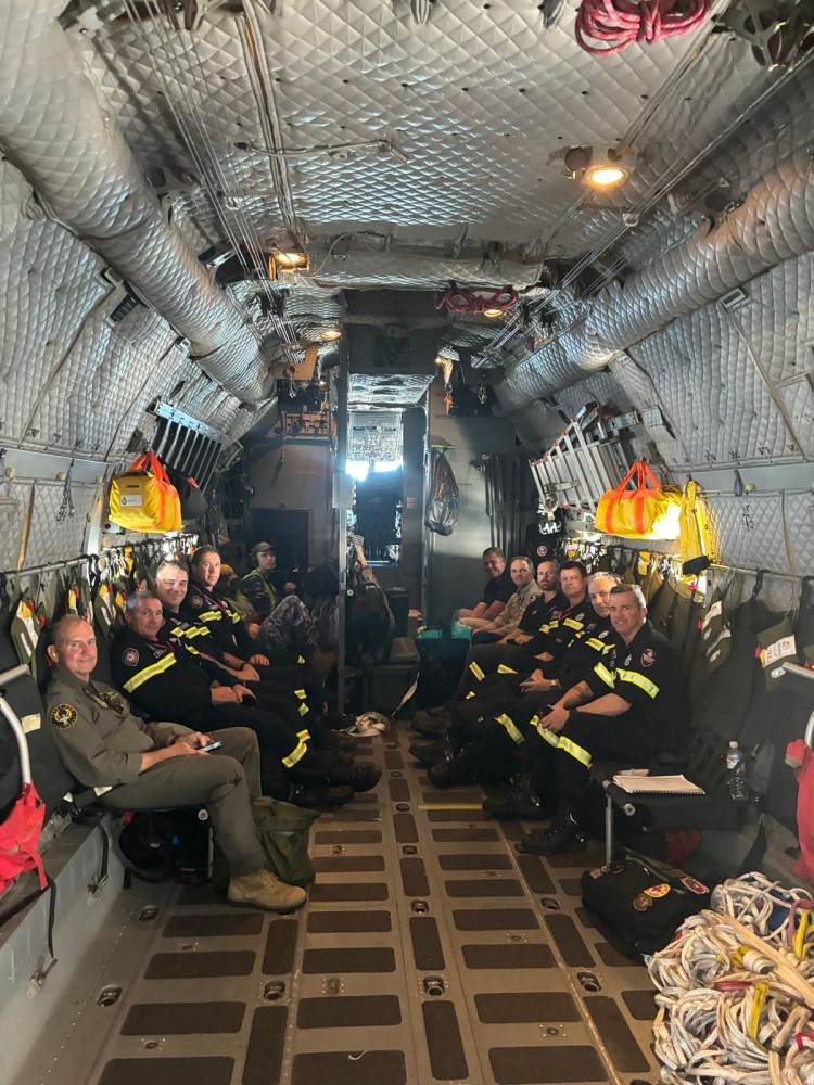 Aid workers seated in an airforce plane ready for takeoff